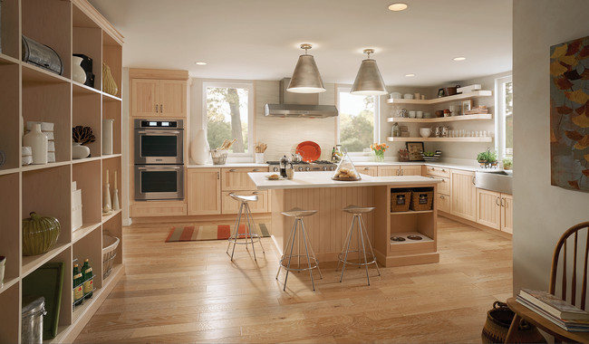 Long rows of open shelving for dishes, light woods and beaded cabinet doors give this progressive kitchen a decidedly upscale Scandinavian feel.